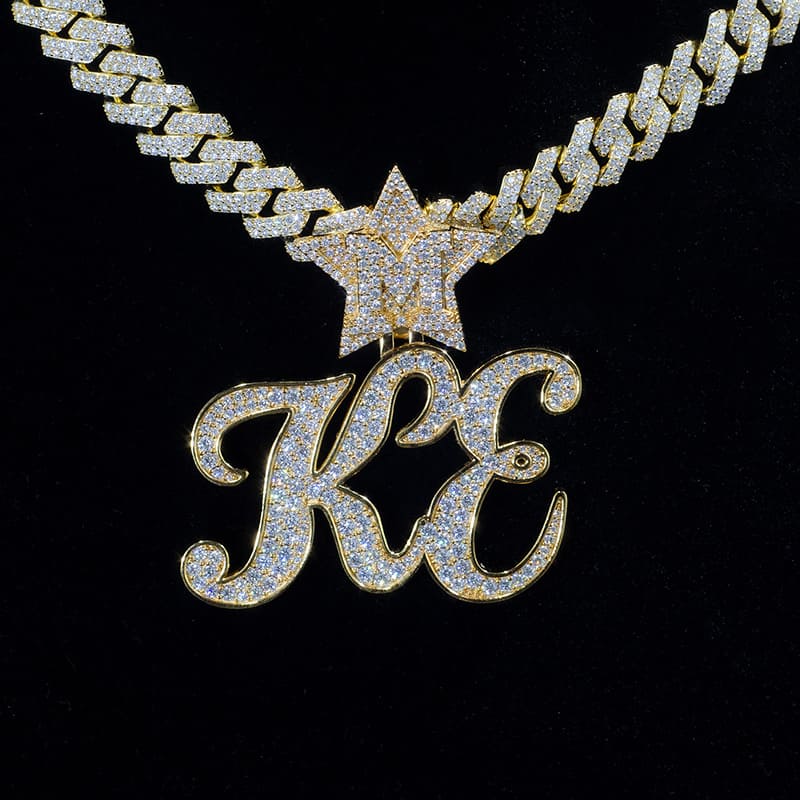 Front on shot of a custom diamond KE inital pendant and necklace on a dark black background.