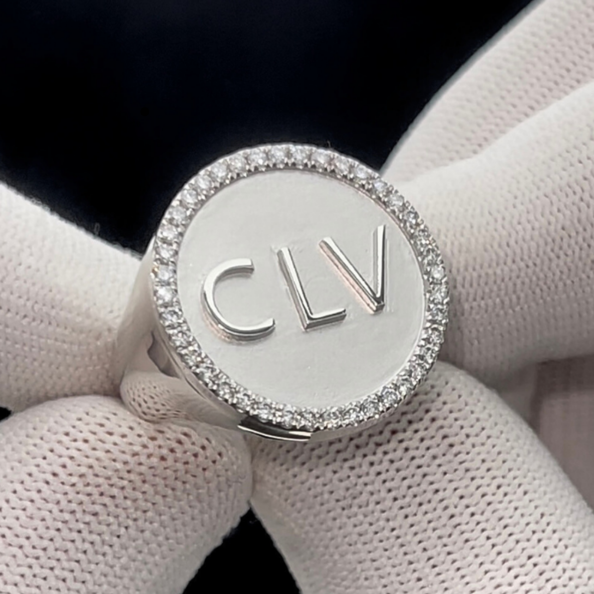 This is an extreme close up of a custom initial Signet ring with the initials being CLV. this ring is in platinum 