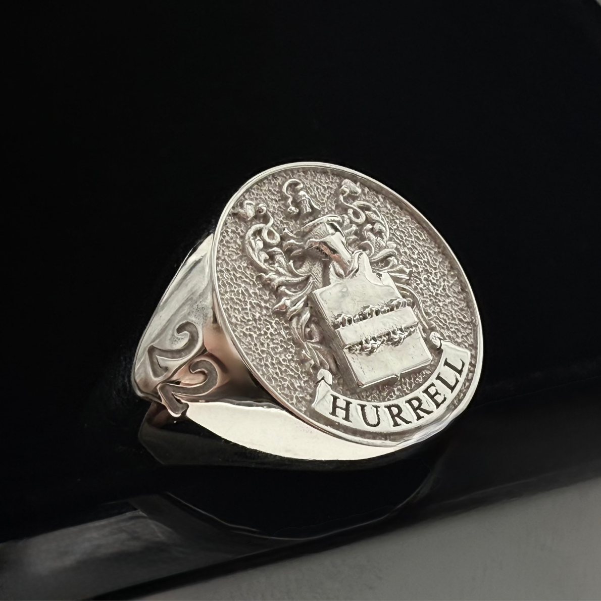 A close up shot of a Custom Family Crest Signet ring made from sterling silver