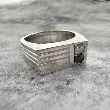 Close up shot of a custom gemstone signet ring in sterling silver on a grey textured background