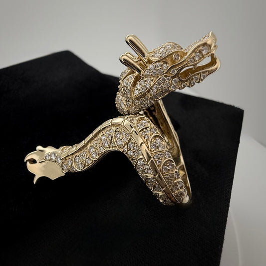 side shot of a custom Diamond dragon ring in 14k yellow gold. on a black and white background