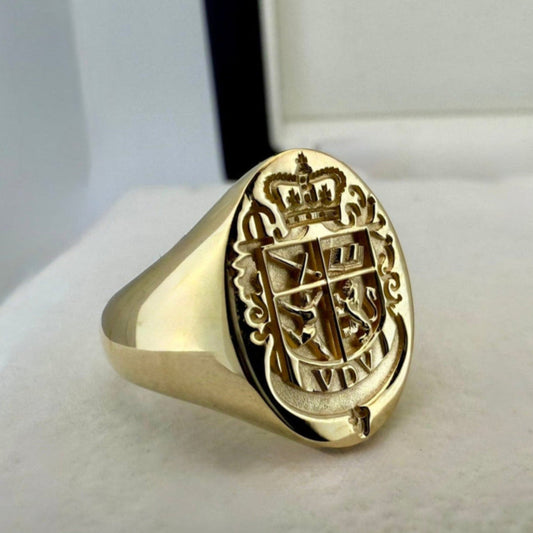 A custom Gold Signet ring with a detailed family crest close up angled shot